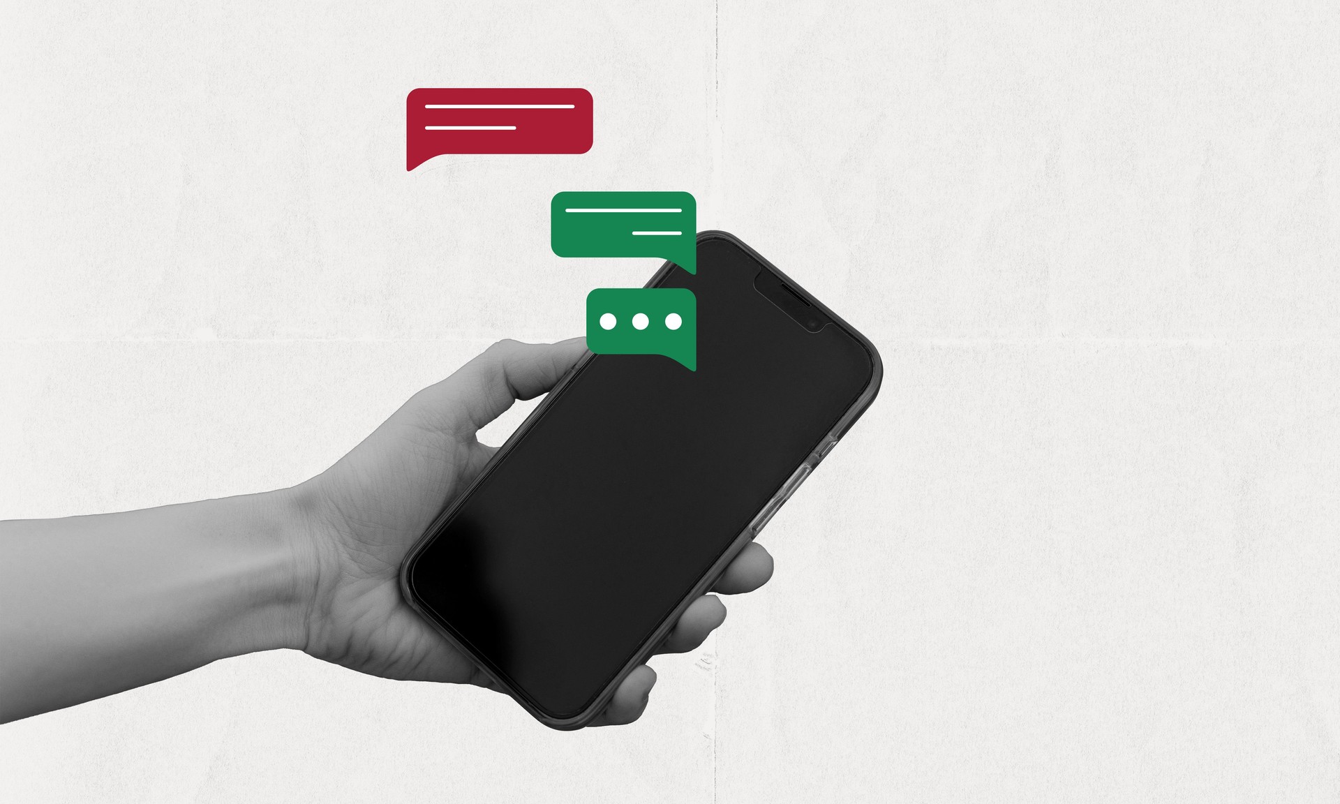 Hand holding phone with pop up chat bubble, online conversation concept